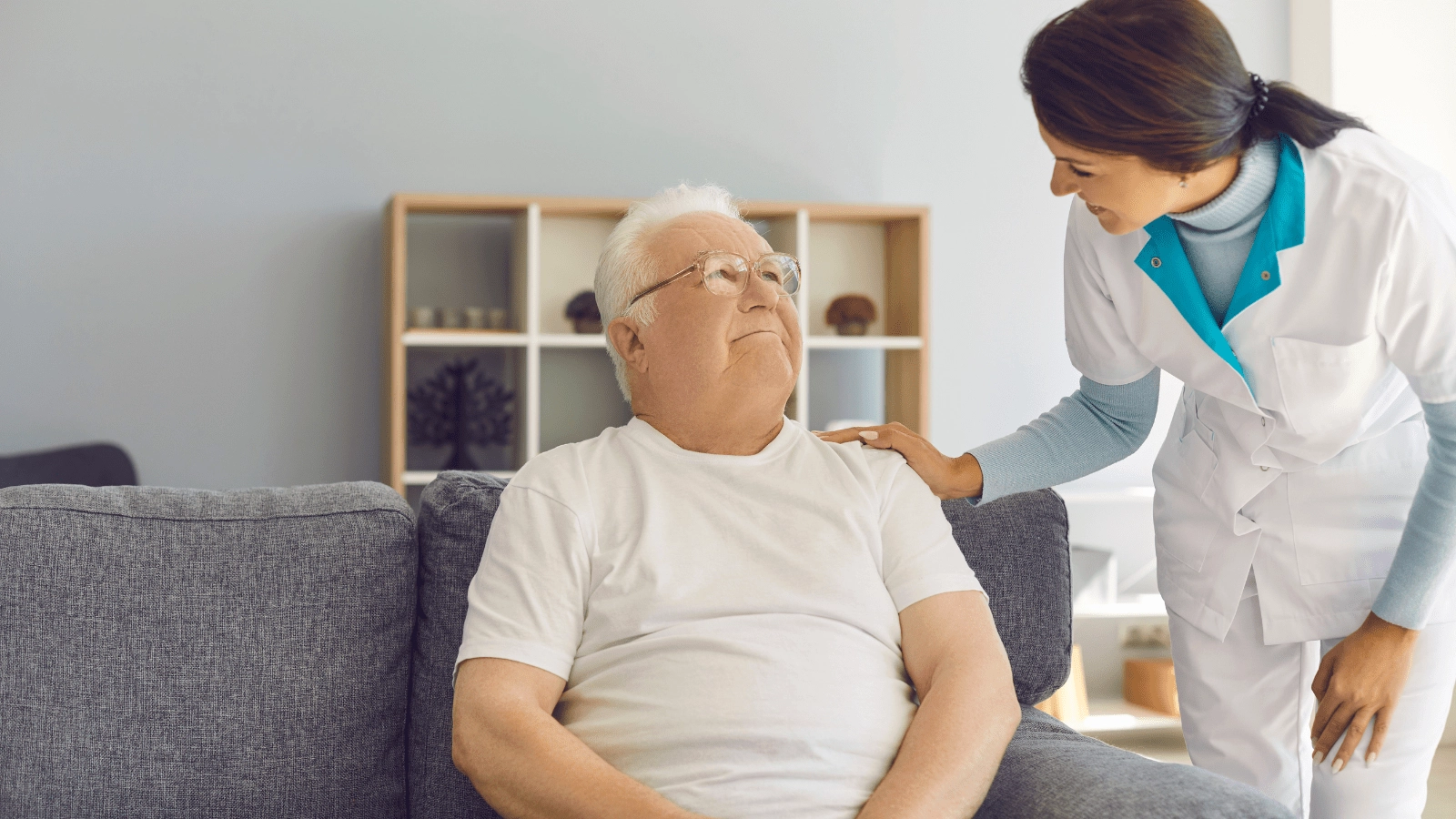 A woman provides long-term care services to a senior man.