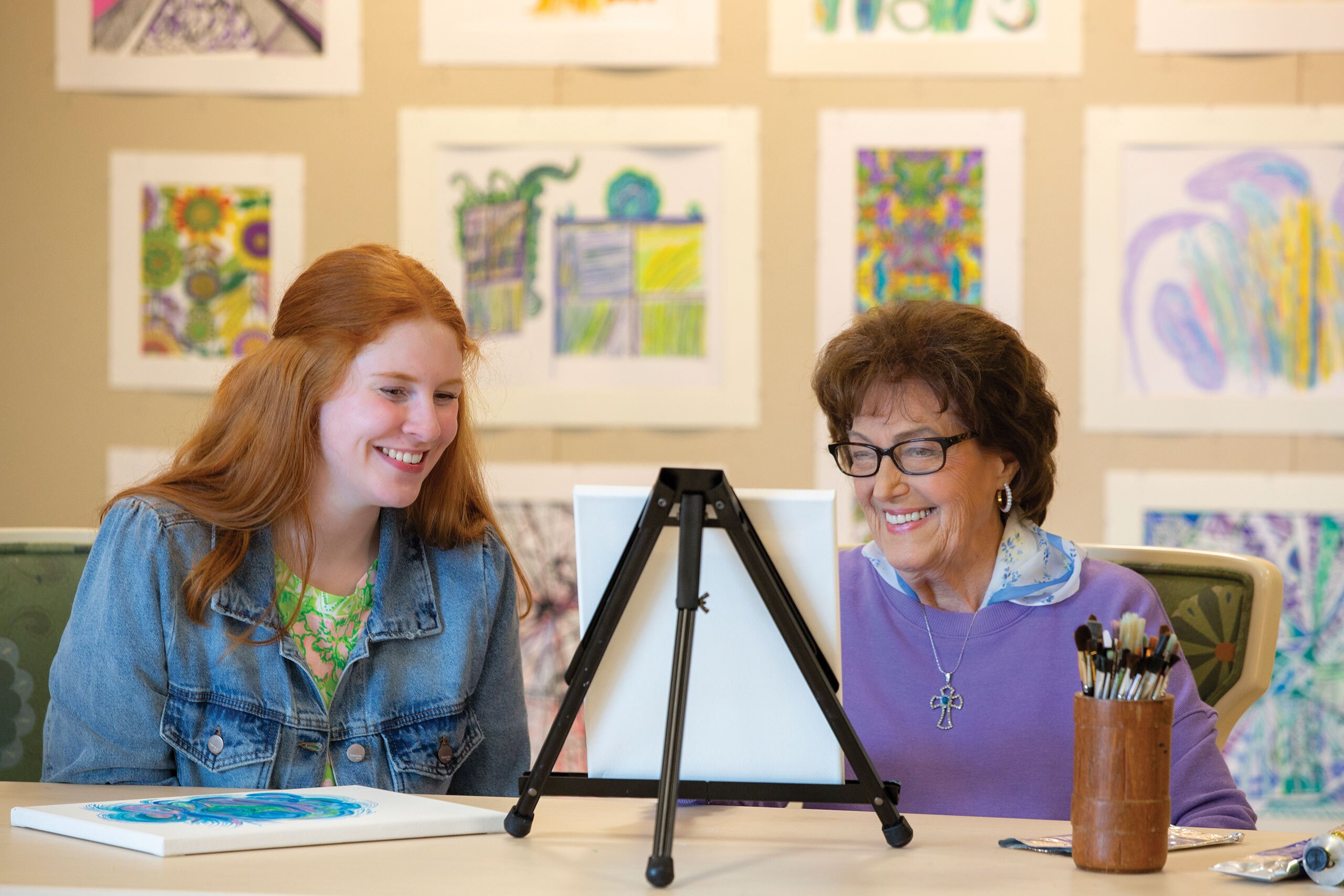 Two ladies admiring a painting.