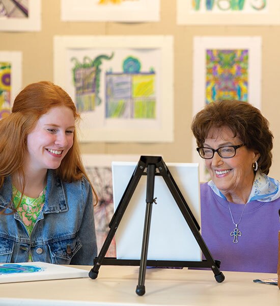 Two ladies admiring a painting.