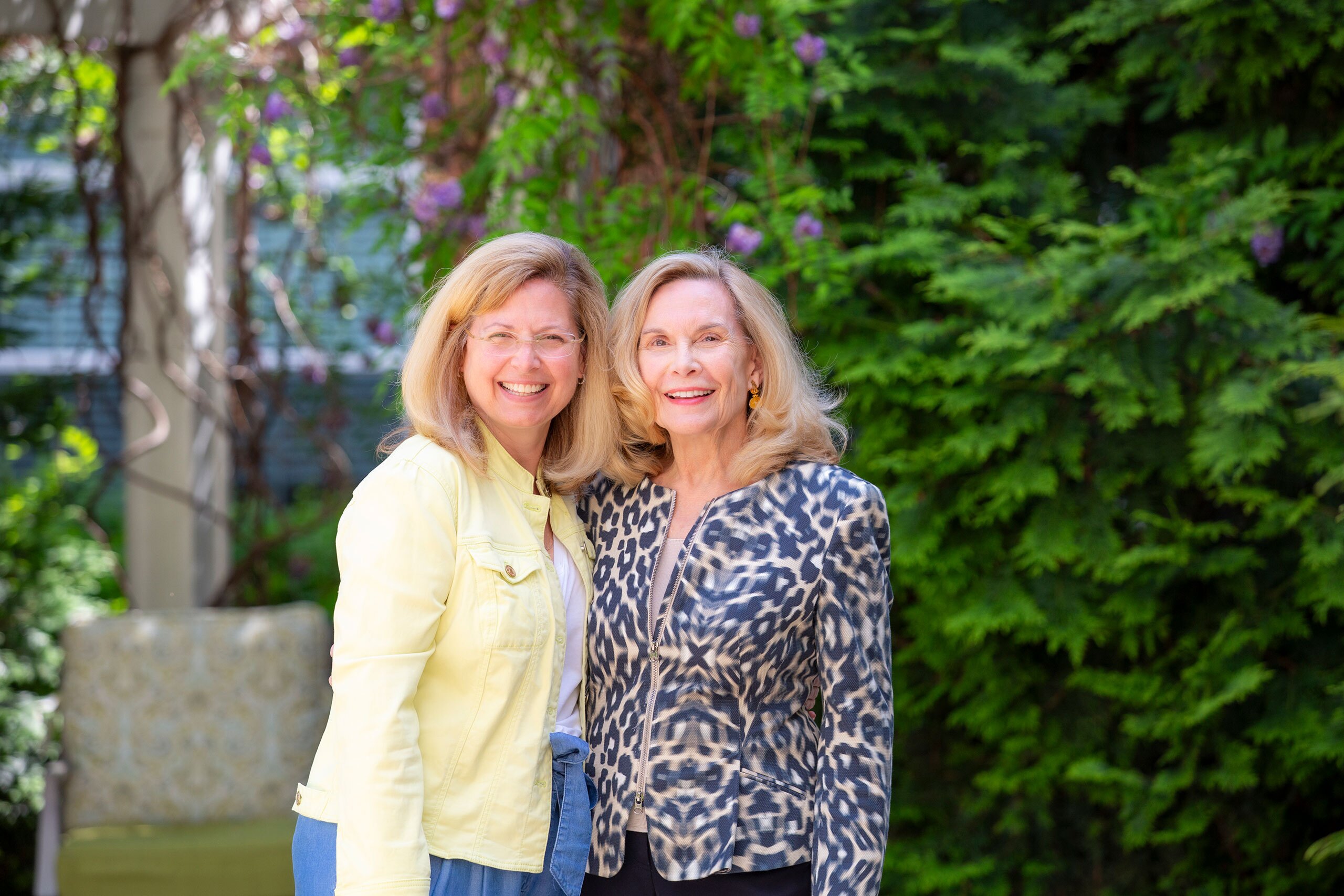 Two ladies smiling outdoors.