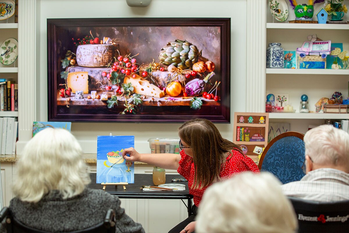 Residents receive painting instructions in class.