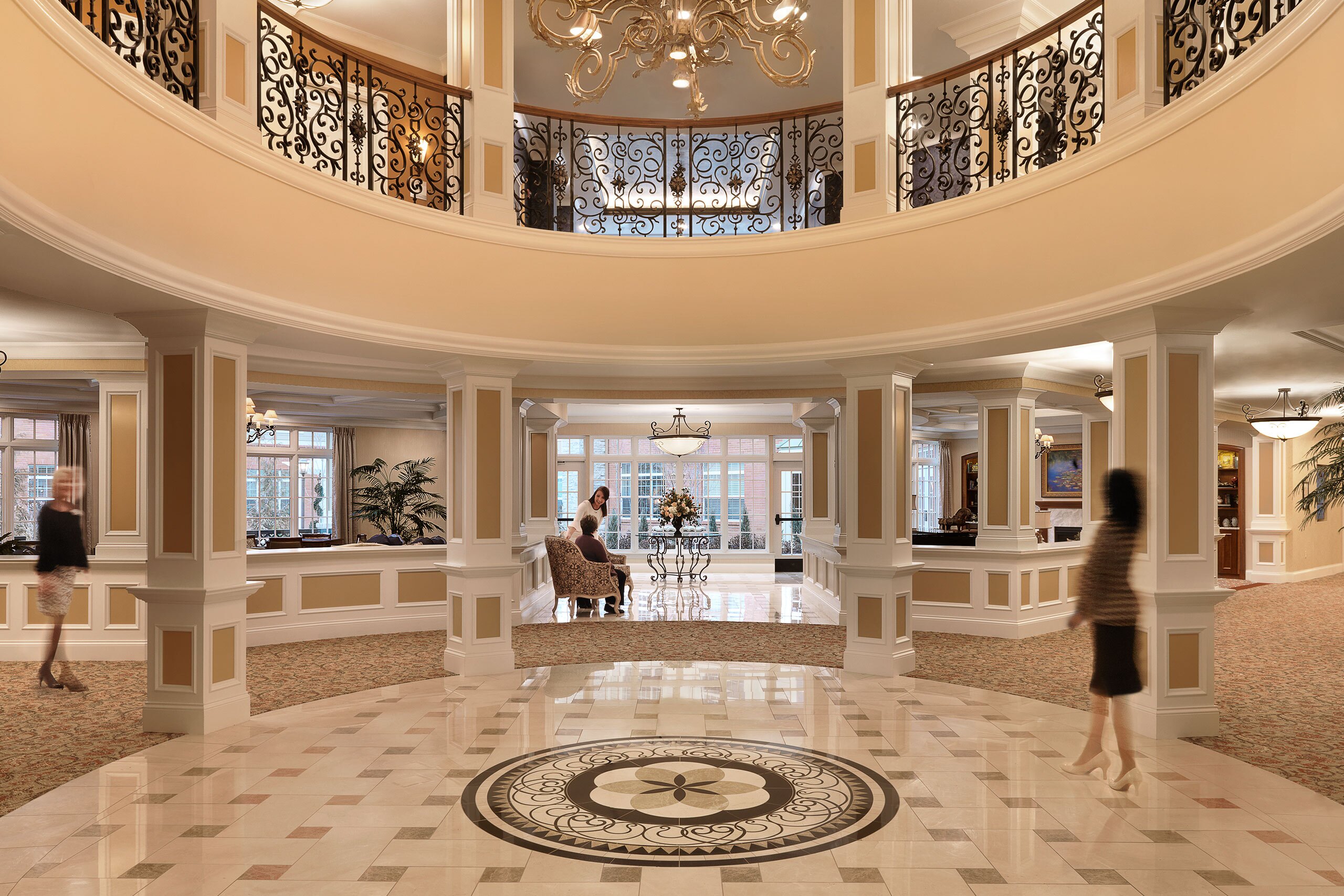 Staff and residents in the grand lobby at McKnight Place