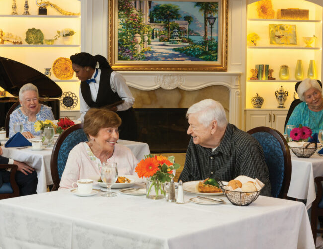 Man and woman sitting in the dining room smiling at each other