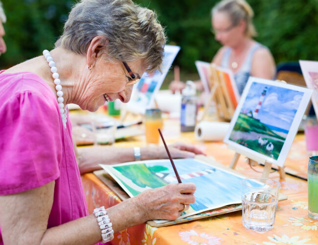 McKnight Place resident painting in watercolors.