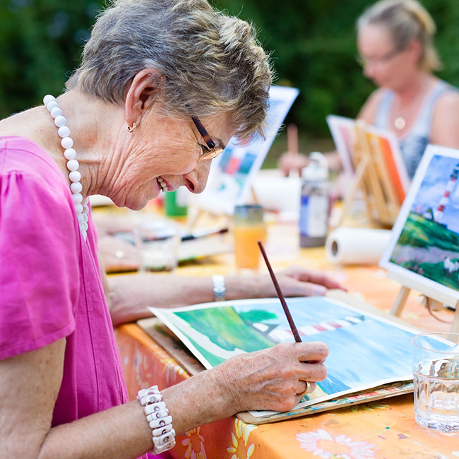 McKnight Place resident painting in watercolors.