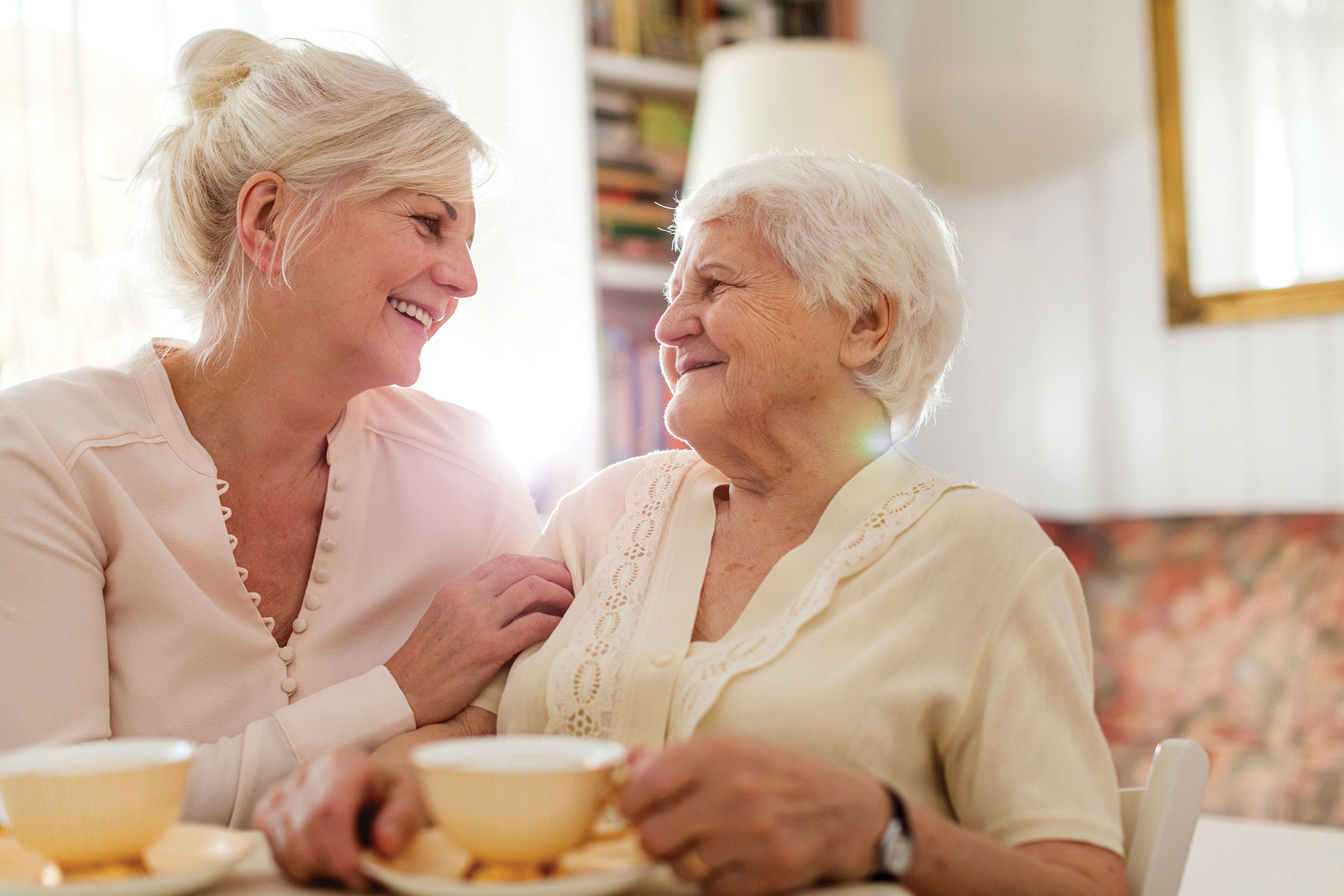 A mother and daughter having tea.