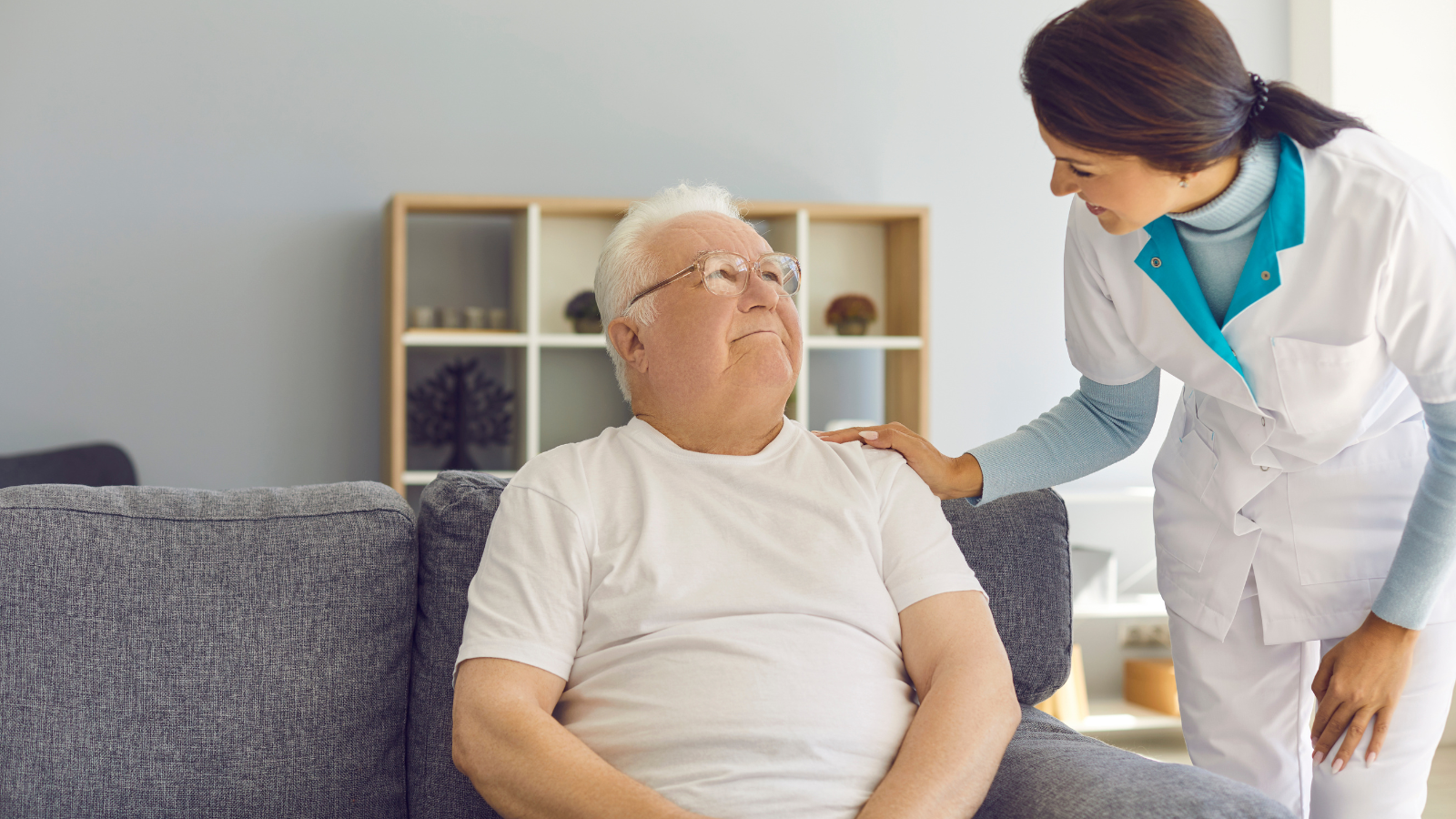 A woman provides long-term care services to a senior man.