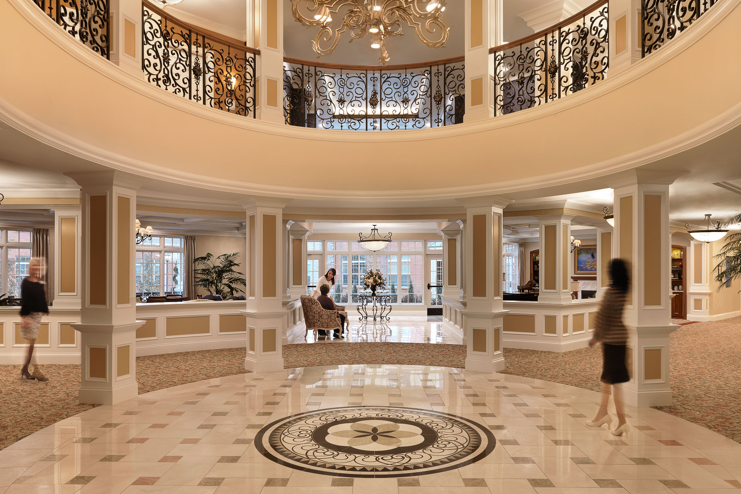 Staff and residents in the grand lobby at McKnight Place